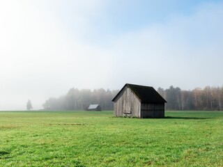 Scenic view of a small wooden hut built in an open field in a rural area in Liezen, Austria.