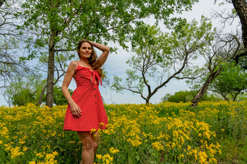 A Lovely Brunette Model Poses In A Field Of Yellow Flowers In A Texas Prarie