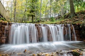 Beautiful landscape of a waterfall in a forest in Latvia