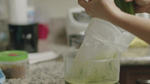 Closeup of pouring pennywort juice into muslin bag