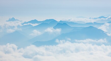 Fototapeta na wymiar Blue skyline of Untersberg massif, mountain peaks of the Berchtesgaden Alps in clouds