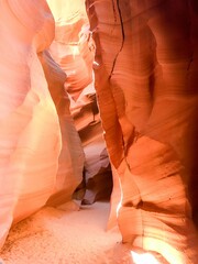 Vertical shot of a red cave illuminated by bright sunlight