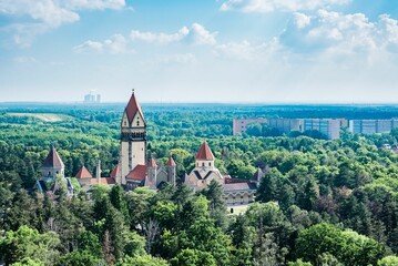 Drone view of the South Cemetery surrounded by many green trees and buildings in Leipzig, Germany