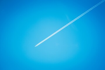 Trace of a plane in a blue sky.
