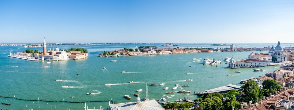 Drone panoramic view of San Giorgio Maggiore Island with boats in the sea and Cini foundation