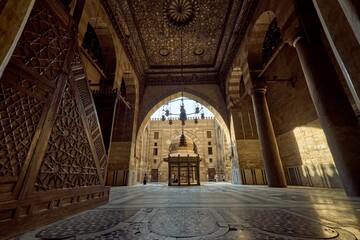 Medieval Cairo's mosque-madrasa with intricate decorations and architectural features