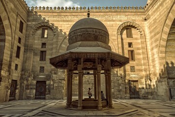 Medieval Cairo's mosque-madrasa with intricate decorations and architectural features
