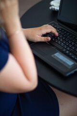 women's hands lying on laptop keyboard. a woman's hand with a watch 