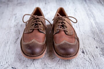 Closeup shot of women's cream flat boots on a wooden background