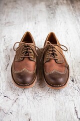 Closeup vertical shot of women's cream flat boots on a wooden background