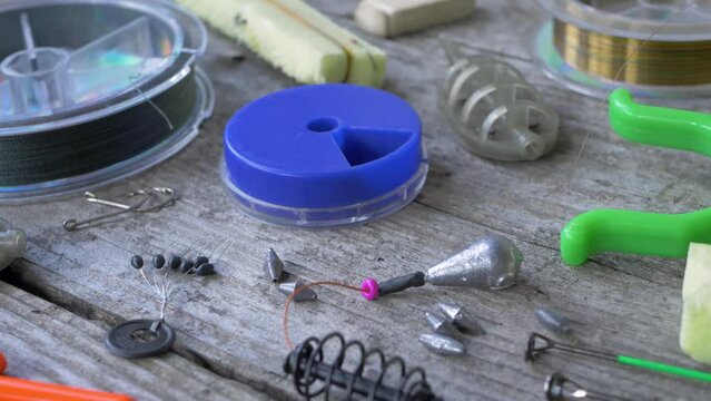 Fishering tackle with hooks, fishing line cord, weight sinker or knoch. Ready for start of fishing season. Enjoying hobby. Get ready for fishing trip