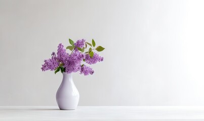  a white vase filled with purple flowers on top of a white counter top next to a white wall and a white wall behind the vase.  generative ai