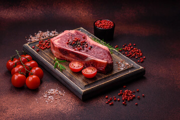 Fresh juicy raw new york beef steak with salt, spices and herbs