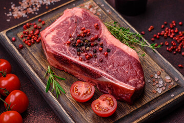 Fresh juicy raw new york beef steak with salt, spices and herbs
