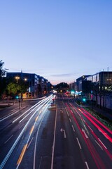 Fototapeta na wymiar Vertical drone shot of asphalt road with long exposure lights in the evening