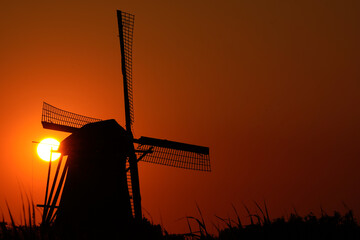 A Dutch windmill in World Heritage Kinderdijk during sunset, knowns as 'Nederwaard Molen No. 3'