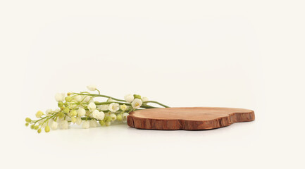 Wooden stump platform podium and lily of the valley background. Minimal empty display product...