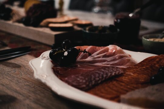 Closeup shot of a meat in a white plate on the dinner table.