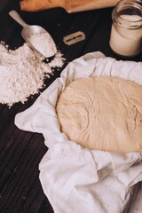 Dough with flour and roller on table