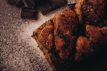 Freshly baked orange loaf with melty chocolate chips placed on top, with a few scattered