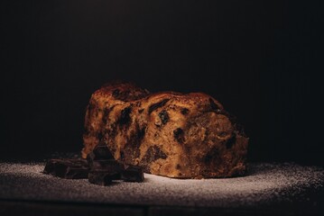 chocolate chip bread with one slice taken from the back on a table
