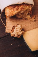 Vertical of freshly baked Italian bread put on the table with cheese