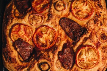 this is the pizza being baked with tomatoes and sausages