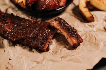Closeup of tasty village potatoes and barbecue meat on the pan