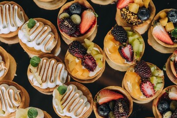 small pastry cups that are made out of cones and decorated with fresh fruit