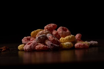 Colorful pile of cereal on a wooden table