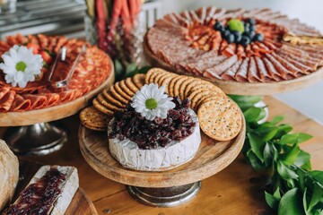 Wooden table with a variety of cheese arranged on plates and bowls