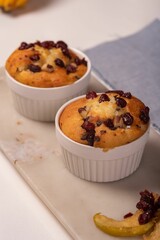 Vertical shot of cranberry muffins on a white plate