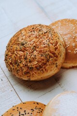 Vertical of the freshly baked bun breads put on the white table surface