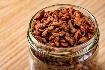Jar of chocolate cereal on a wooden surface