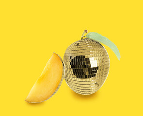 Disco ball with plum inside on yellow background