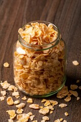 Vertical shot of cereal in a jar on a wooden surface