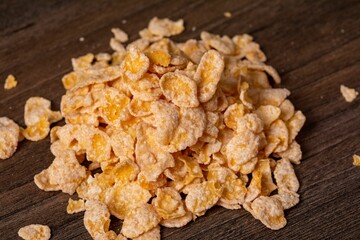 Close up shot of a small pile of breakfast cereal flakes against a white background