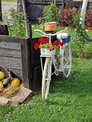 White vintage decorated bicycle in the green garden