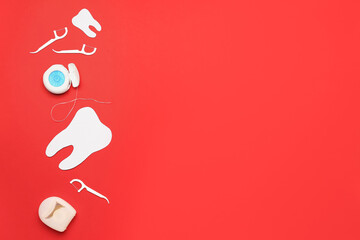 Dental flosses, toothpicks and tooth model on red background
