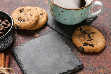 Drink coasters with cup of coffee, cookies and cinnamon on brown grunge table
