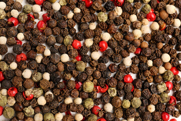 Aromatic peppercorns as background, closeup