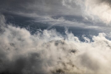 Dramatic ambiance of white clouds over the Gantrisch Mountain in Swiss Alps