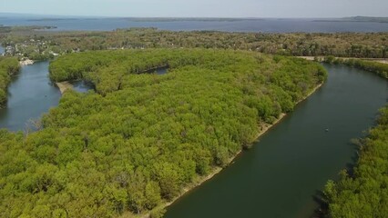 Scenic view of the tranquil lake Champlain and the river Winooski surrounded by evergreen trees