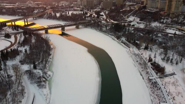 Scenic drone view of overlooking bridges over the North Saskatchewan river during the sunset