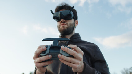 Man pilot a drone with technologic virtual reality glasses and remote controller © Polonio Video