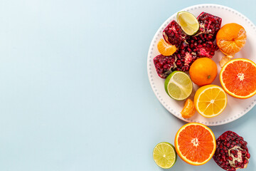 Plate of fresh citrus fruits slices oranges and grapefruits