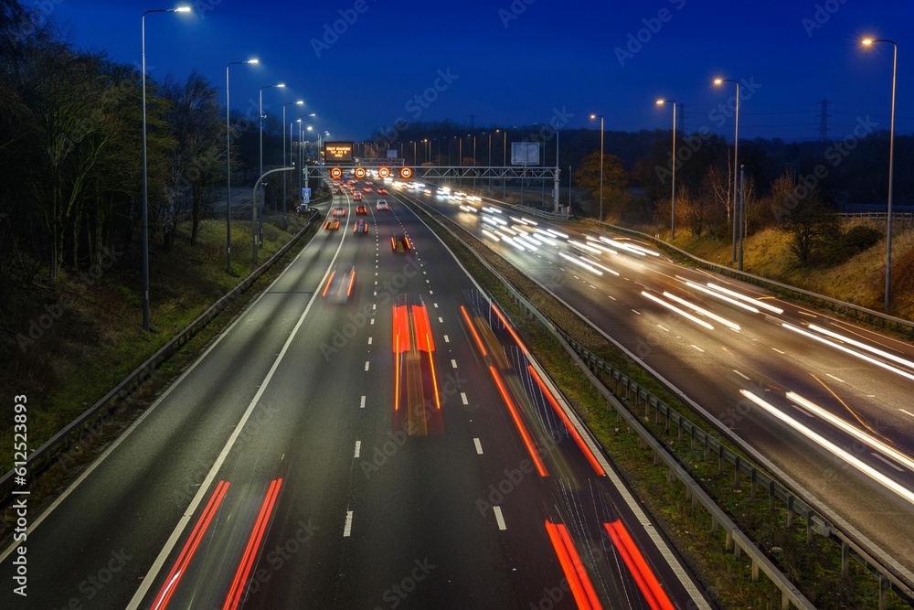 Sticker Fast moving traffic on the M42 passes through an active traffic management system during rush hour.