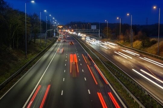 Fast moving traffic on the M42 passes through an active traffic management system during rush hour.