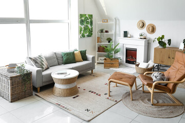 Interior of cozy living room with sofa, armchair and fireplace