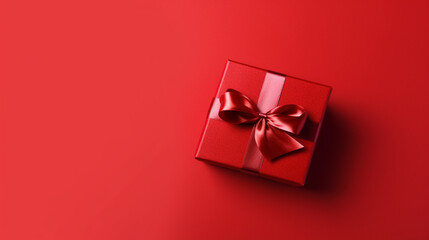 beautiful red square gift box with red bow on side on red background, top view - obrazy, fototapety, plakaty